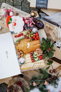 St. Nicolas Box including wickmann, cheese, sausages, veggies, fruits, sweets and baguette. Decorated in a beautiful catering box along with a bag of sweets.